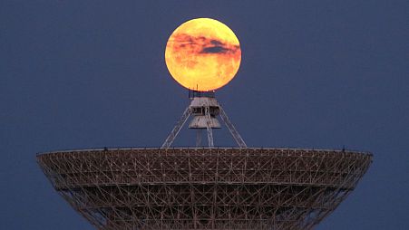 The moon is seen through clouds behind the radio telescope RT-70 in the village of Molochnoye, Crimea May 16, 2022