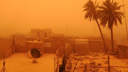 A thick layer of orange dust covers Baghdad