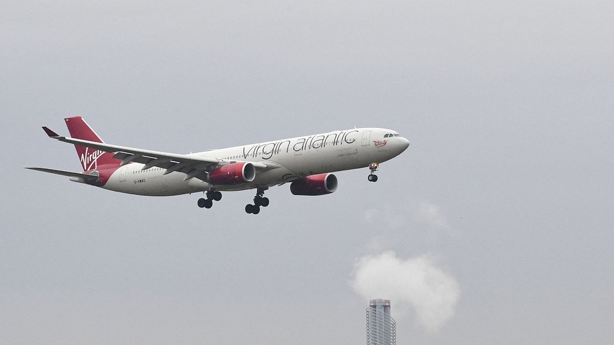 A Virgin Atlantic Airbus A330 passenger plane is seen above a hotel coming in to land at London Heathrow Airport in west London on February 14, 2021.
