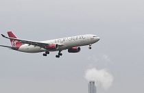 A Virgin Atlantic Airbus A330 passenger plane is seen above a hotel coming in to land at London Heathrow Airport in west London on February 14, 2021.