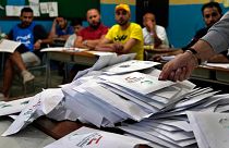 Election officials count ballots shortly after polling stations closed in the northern city of Tripoli.