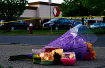 Flowers and candles lay outside the scene of a shooting at a supermarket in Buffalo.