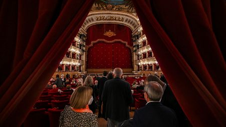 Spectators arrive at the Teatro San Carlo in Naples on April 27, 2022 to attend a show of Puccini's "Tosca".
