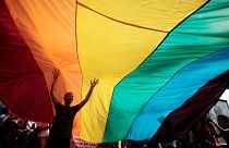 A man is seen underneath the rainbow flag during the the fourth gay pride rally in the Bulgarian capital of Sofia on Saturday, June 18, 2011