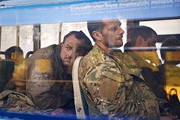 Ukrainian servicemen sit in a bus after they were evacuated from the besieged Mariupol's Azovstal steel plant, Tuesday, May 17, 2022.
