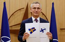 NATO Secretary-General Jens Stoltenberg displays documents as Sweden and Finland applied for membership in Brussels, Belgium, Wednesday May 18, 2022
