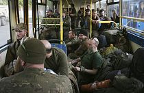 Ukrainian servicemen sit in a bus after they were evacuated from the besieged Mariupol's Azovstal steel plant. Tuesday, May 17, 2022.