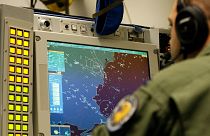 Captain Brandon Snyder of Boise, Idaho, of the E-3A Awacs Component crew controles computer and radar scope screens during a patrol over Romania and Poland, April 18, 2014.