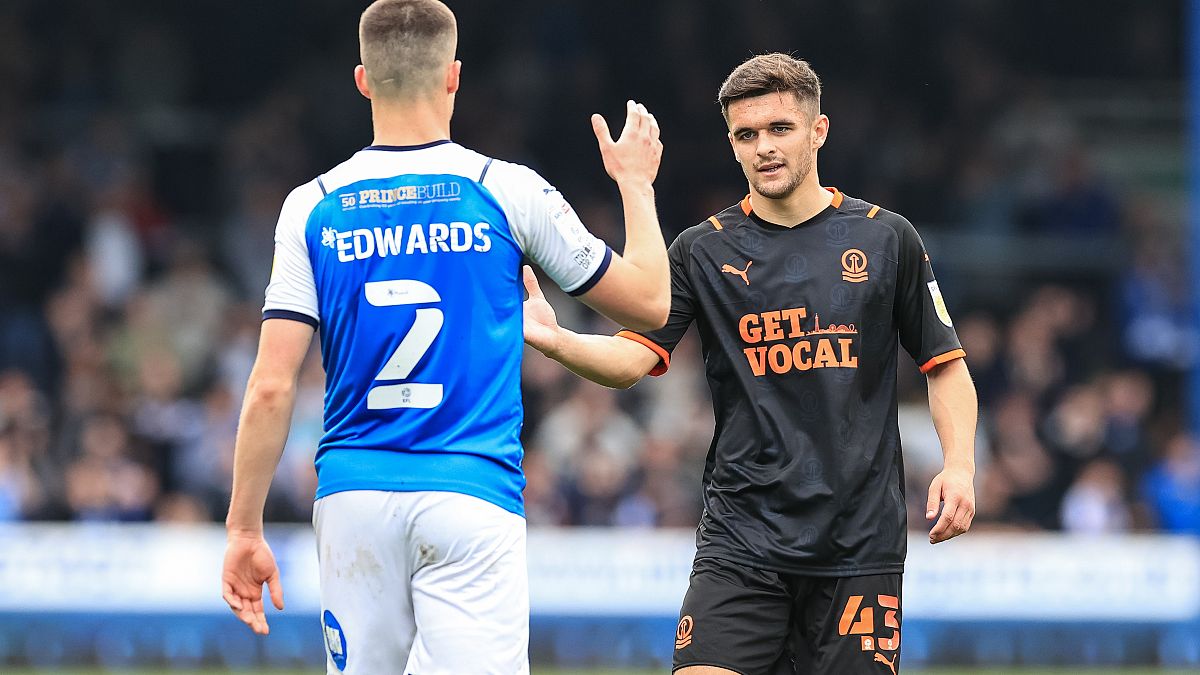 Jake Daniels of Blackpool, right, with Ronnie Edwards of Peterborough United after a match this year.