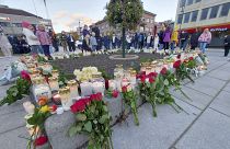 Flowers and candles are placed at a memorial after the attack in Kongsberg.