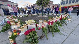 Flowers and candles are placed at a memorial after the attack in Kongsberg.