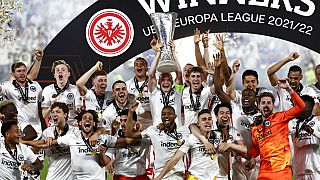 Frankfurt players lift the trophy for winners of the Europa League final soccer match between Eintracht Frankfurt and Rangers FC at the Ramon Sanchez Pizjuan stadium in Spain.