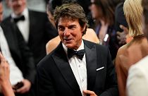 Tom Cruise saluant la foule sur les marches du tapis rouge au Festival de Cannes, ce mercredi