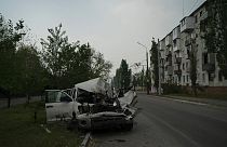 A heavily damaged car is seen on a street after a Russian attack in Severodonetsk, Luhansk region, Ukraine