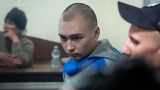 Russian army Sergeant Vadim Shishimarin, 21, is seen behind a glass during a court hearing in Kyiv, Ukraine, Wednesday, May 18, 2022.