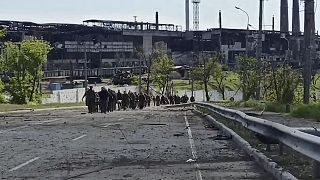 Ukrainian servicemen leave the besieged Azovstal steel plant in Mariupol, Ukraine, seen in a video from Russia's defence ministry released on May 18, 2022.
