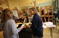 People cast their votes at a polling station in Brussels for the 2019 European Parliament elections.