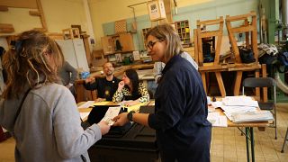 People cast their votes at a polling station in Brussels for the 2019 European Parliament elections.