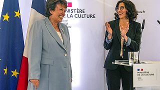 French Culture Minister Roselyne Bachelot, left, smiles as newly named French Culture Minister Rima Abdul-Malak