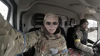 Yuliia Paievska, known as Taira, and her driver Serhiy sit in a vehicle in Mariupol, Ukraine on March 9, 2022.