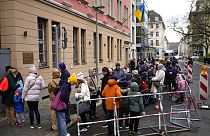 People from the Ukraine most of them refugees fleeing the war, wait in front of the consular department of the Ukrainian embassy in Berlin, Germany, Wednesday, April 6, 2022