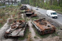 Cars pass by destroyed Russian tanks in a recent battle against Ukrainians in the village of Dmytrivka, close to Kyiv, Ukraine, Monday, May 23, 2022