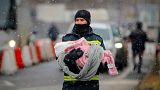 A firefighter holds the baby of a refugee fleeing the conflict from Ukraine at Romanian border