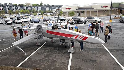 People look over Dr. Akaki Lekiachilli's near life-like replica of an X-Wing Starfighter from Star Wars, which was designed by Cantwell.