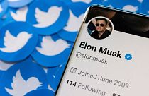 FILE PHOTO: Elon Musk's Twitter profile is seen on a smartphone placed on printed Twitter logos in this picture illustration taken April 28, 2022.