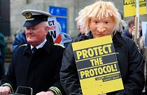 Demonstrators protest outside Hillsborough Castle, ahead of a visit by British Prime Minister Boris Johnson, in Hillsborough, Northern Ireland, Monday, May, 16, 2022.
