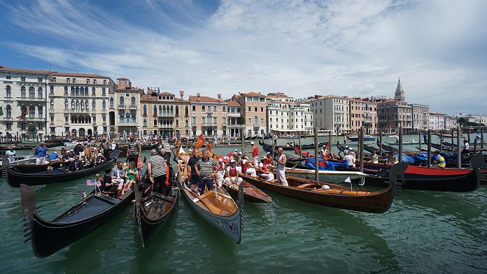 Climate activists in gondolas sail through Venice to protest greenwashing
