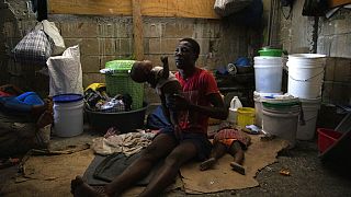 Ideiglenes szálláson élő család Haitin
