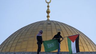 Masked Palestinians carry Palestinian & Hamas flags during Eid al-Fitr celebrations next to Dome of Rock Mosque in Al-Aqsa Mosque compound in Old City of Jerusalem, May 2 2022
