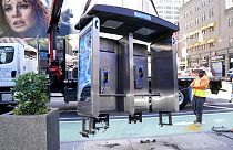 Workers remove the final New York City payphone in Midtown Manhattan