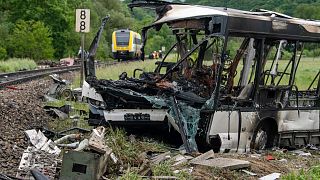 The wreckage of the bus pictured near the railway line at Blaustein.