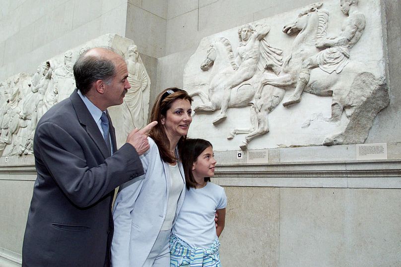 Greek Foreign Minister George Papandreau, accompanied by his wife Anda and daughter Margarita view the Elgin Marbles at the British Museum in London Sunday, June 4, 2000.