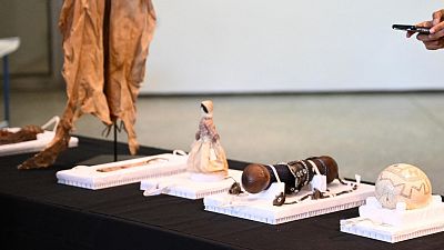 A woman takes pictures of Namibian art pieces from the collection of the Ethnological Museum in Berlin on display A woman takes pictures of Namibian art pieces from the collection of the Ethnological Museum in Berlin on display