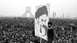 Demonstrators hold up a poster of Ayatollah Khomeini, the former supreme leader of Iran, during a protest in Tehran, 10 Dec, 1978. 