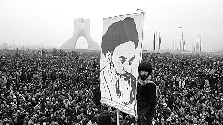 Demonstrators hold up a poster of Ayatollah Khomeini, the former supreme leader of Iran, during a protest in Tehran, 10 Dec, 1978. 