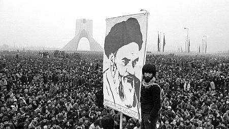 Demonstrators hold up a poster of Ayatollah Khomeini, the former supreme leader of Iran, during a protest in Tehran, 10 Dec, 1978.