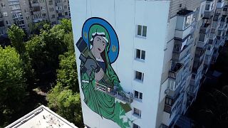 Giant mural of armed saint