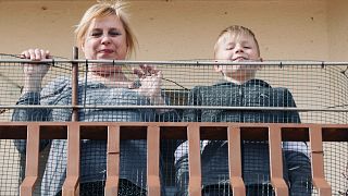 Ukrainian refugee Svetlana and her son Yaroslav on their balcony in Aguilafuente, central Spain.