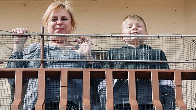 Ukrainian refugee Svetlana and her son Yaroslav on their balcony in Aguilafuente, central Spain.