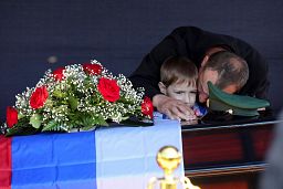 Father and son of Russian Army Sgt. Daniil Dumenko, 35, killed during fighting in Ukraine, mourn during funeral in Volzhsky, Russia, 26 May 2022