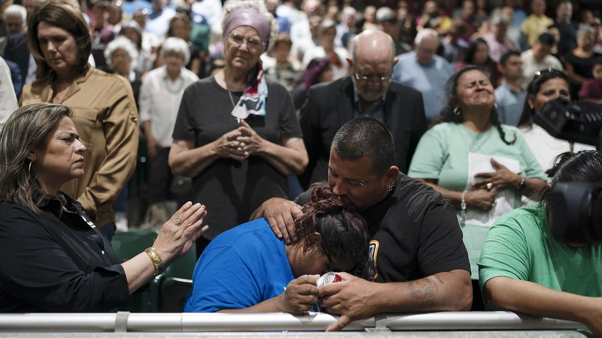 Two family members of one of the victims killed comfort each other during a prayer vigil.