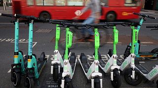 A row of e-scooters from Tier and Lime lined up in Canary Wharf, London.