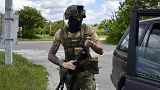 A Ukrainian serviceman boards a car in the village of Mayaky, Donetsk region on 27 May 2022