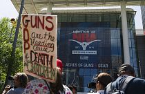 People protest outside the NRA convention.