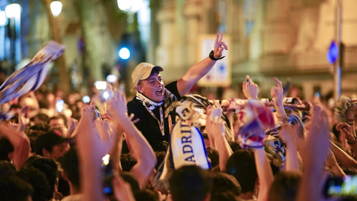 Real Madrid supporters celebrate at the end of the Champions League.