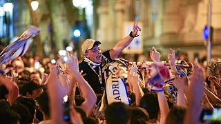 Real Madrid supporters celebrate at the end of the Champions League.